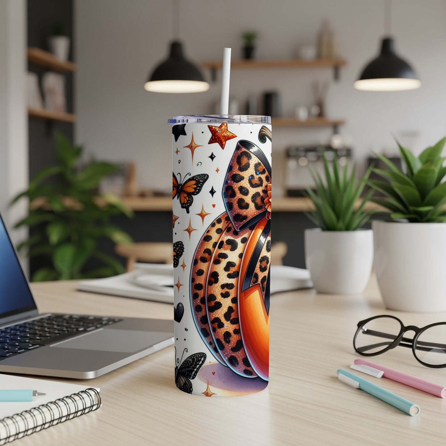Tumbler with leopard print pumpkin, butterflies, and stars design.