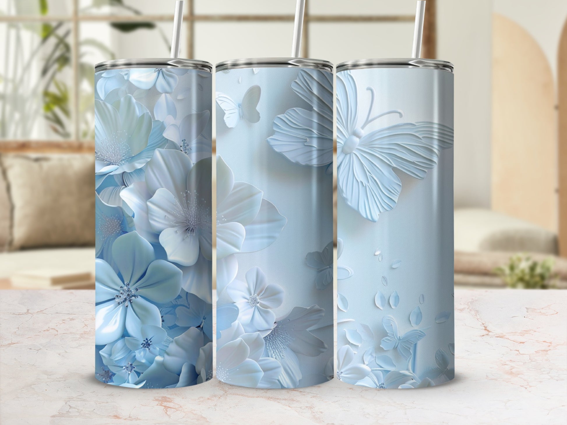 Blue floral and butterfly patterned tumblers with straw.