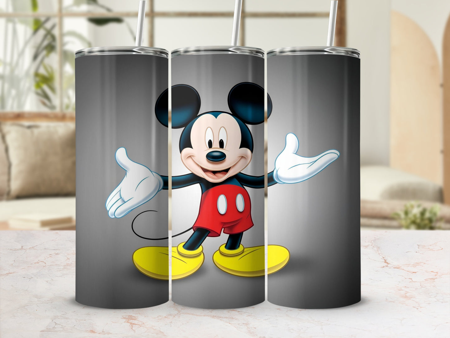 Mickey Mouse on a gray tumbler with a straw.