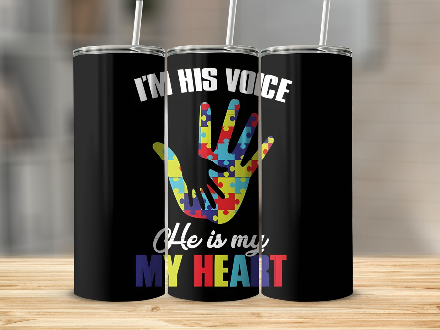 Black tumbler with colorful puzzle hand and text "He is my HEART".