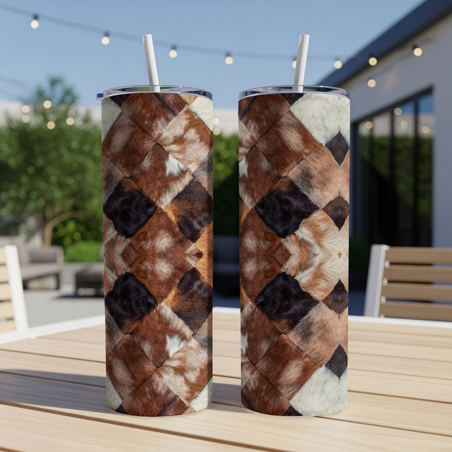Two tumblers with a brown and white patchwork fur pattern sit on a table.