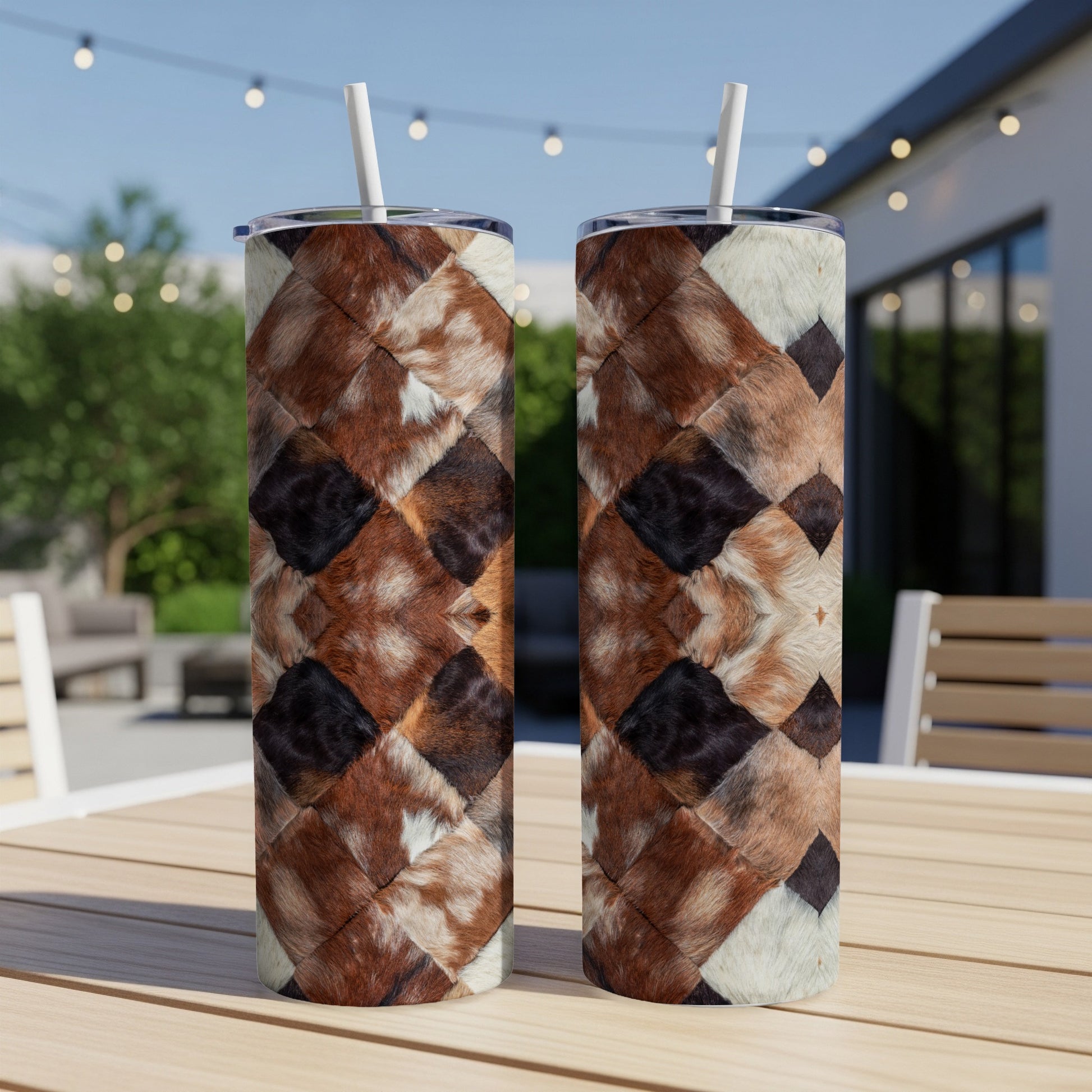 Two tumblers with a brown and white patchwork fur pattern sit on a table.
