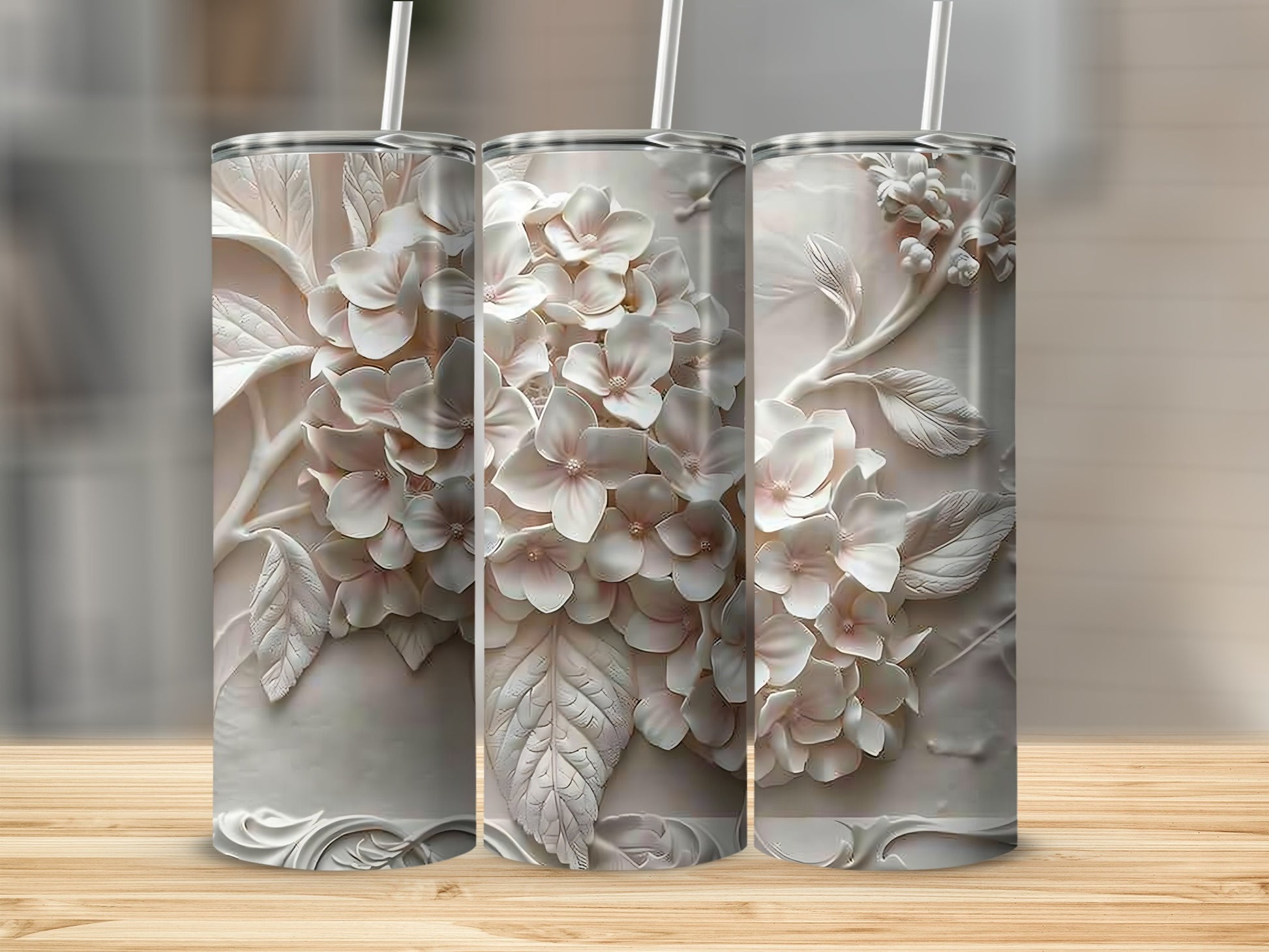Three white tumblers with embossed light pink floral designs.