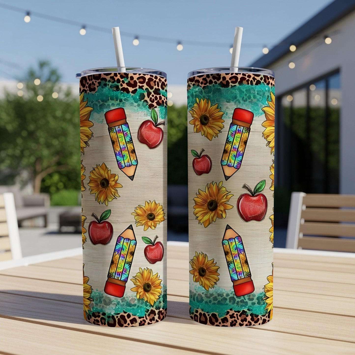 Two tumblers with a school-themed design of pencils, apples, and sunflowers.