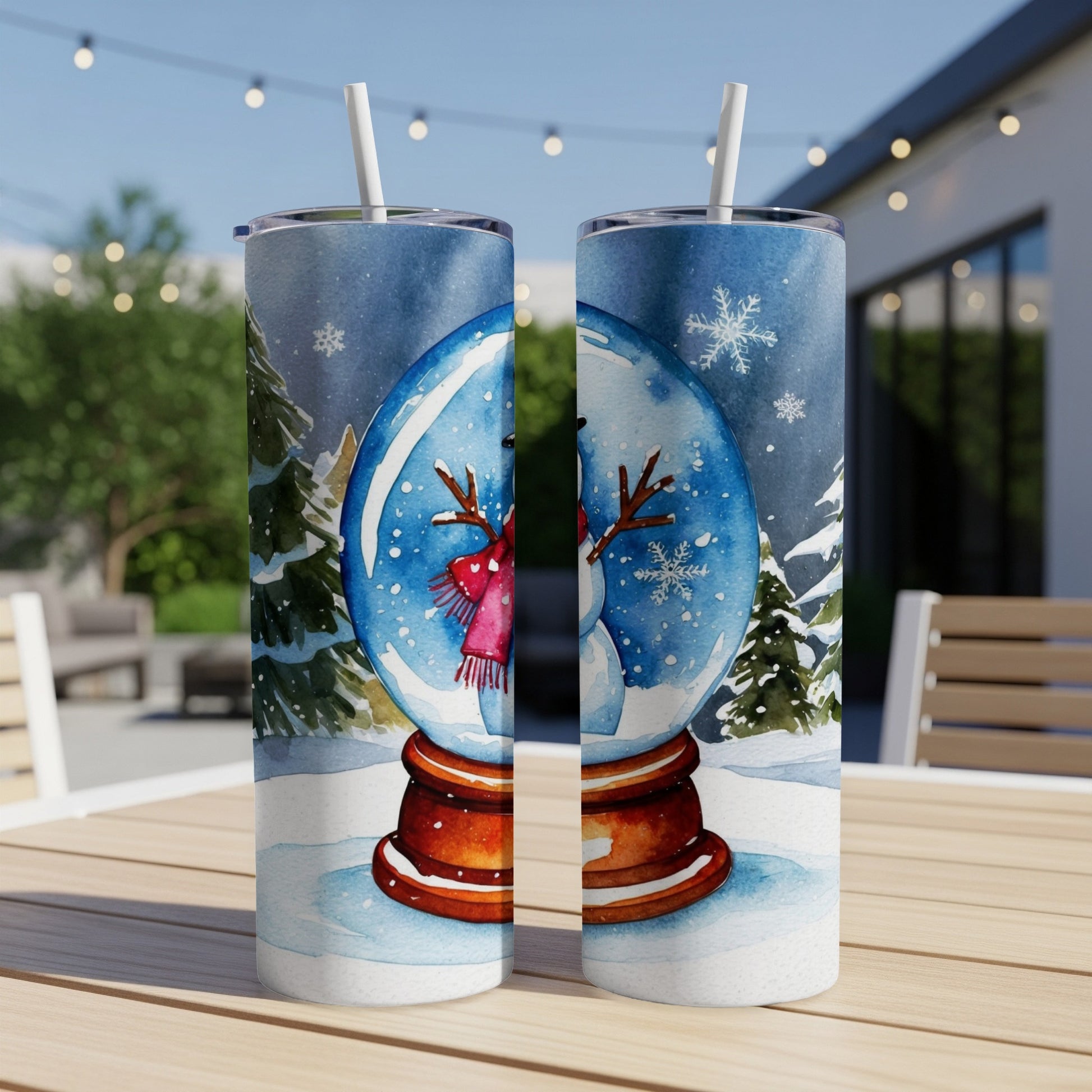 Snow globe tumbler with snowman and winter scene.
