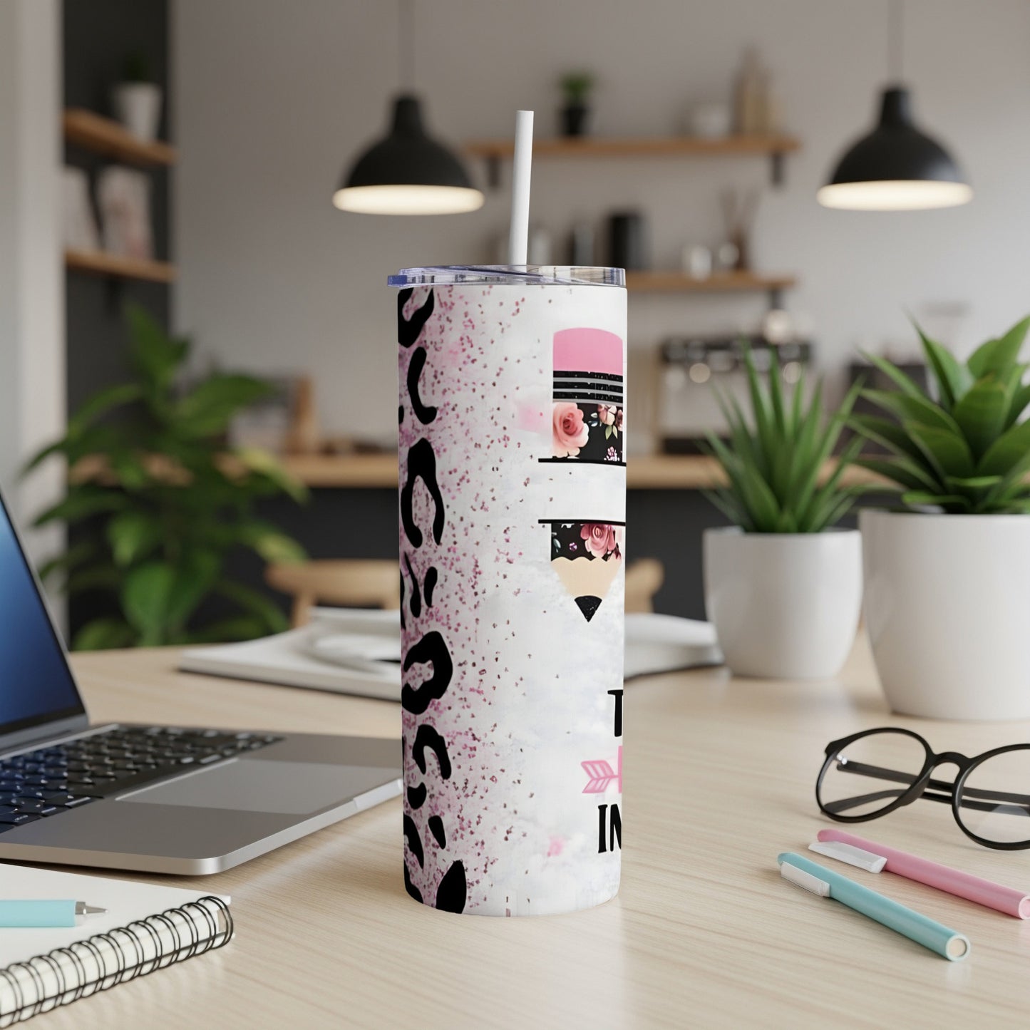 Tumbler with leopard print and floral pencil design.