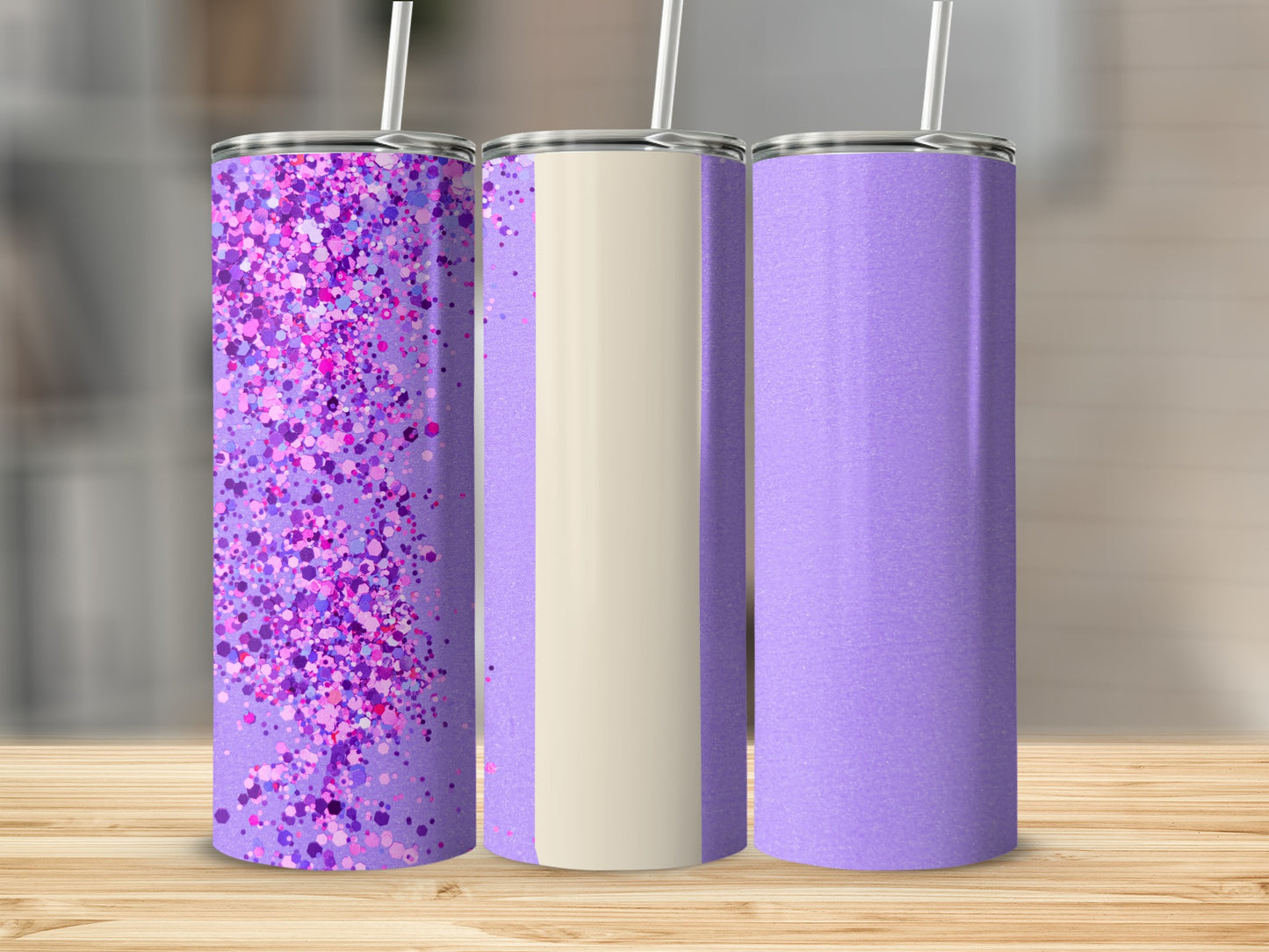 Three purple tumblers with glitter and cream accents on a wooden surface.