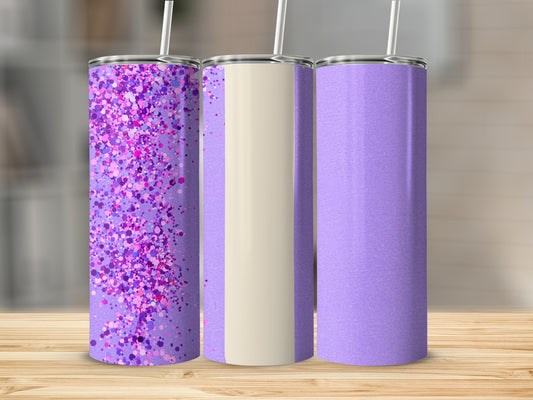 Three purple tumblers with glitter and cream accents on a wooden surface.