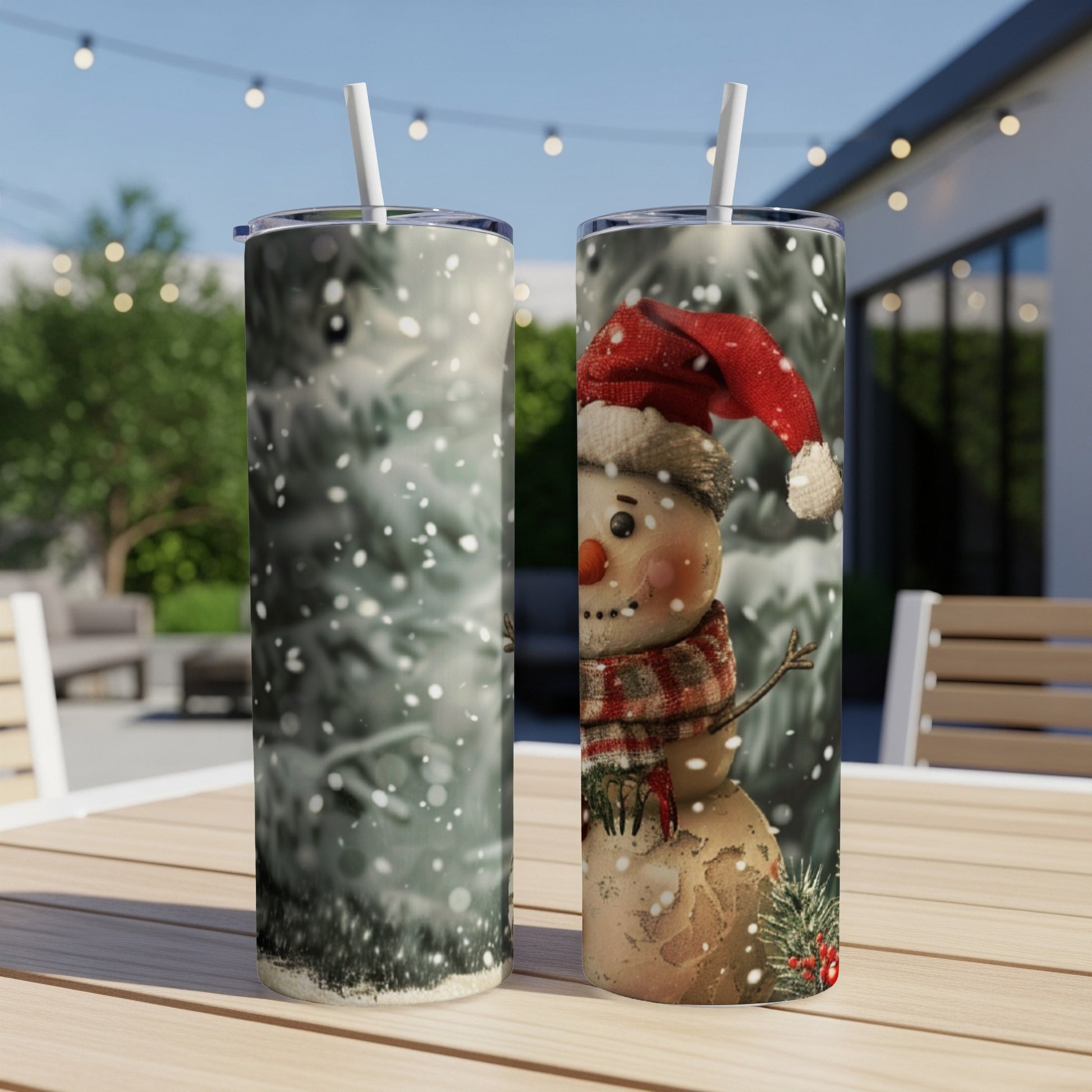 Snowman tumbler with red hat and scarf on a table.