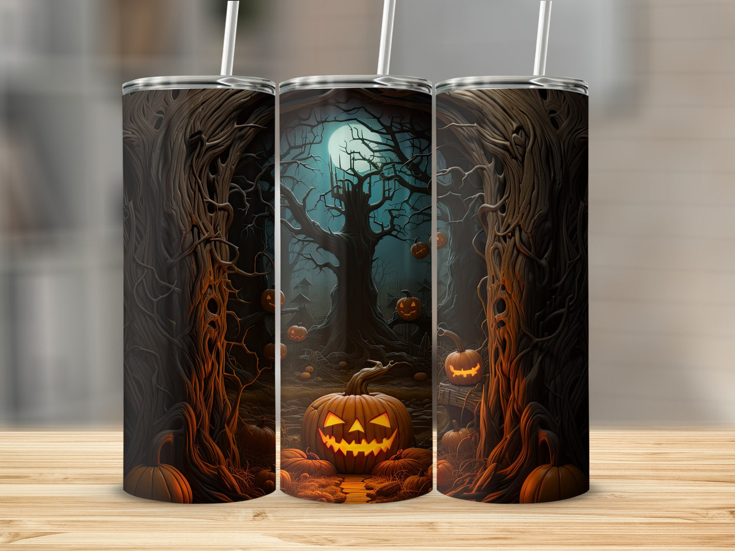 Three tumblers decorated with a spooky Halloween forest scene and jack-o'-lanterns.