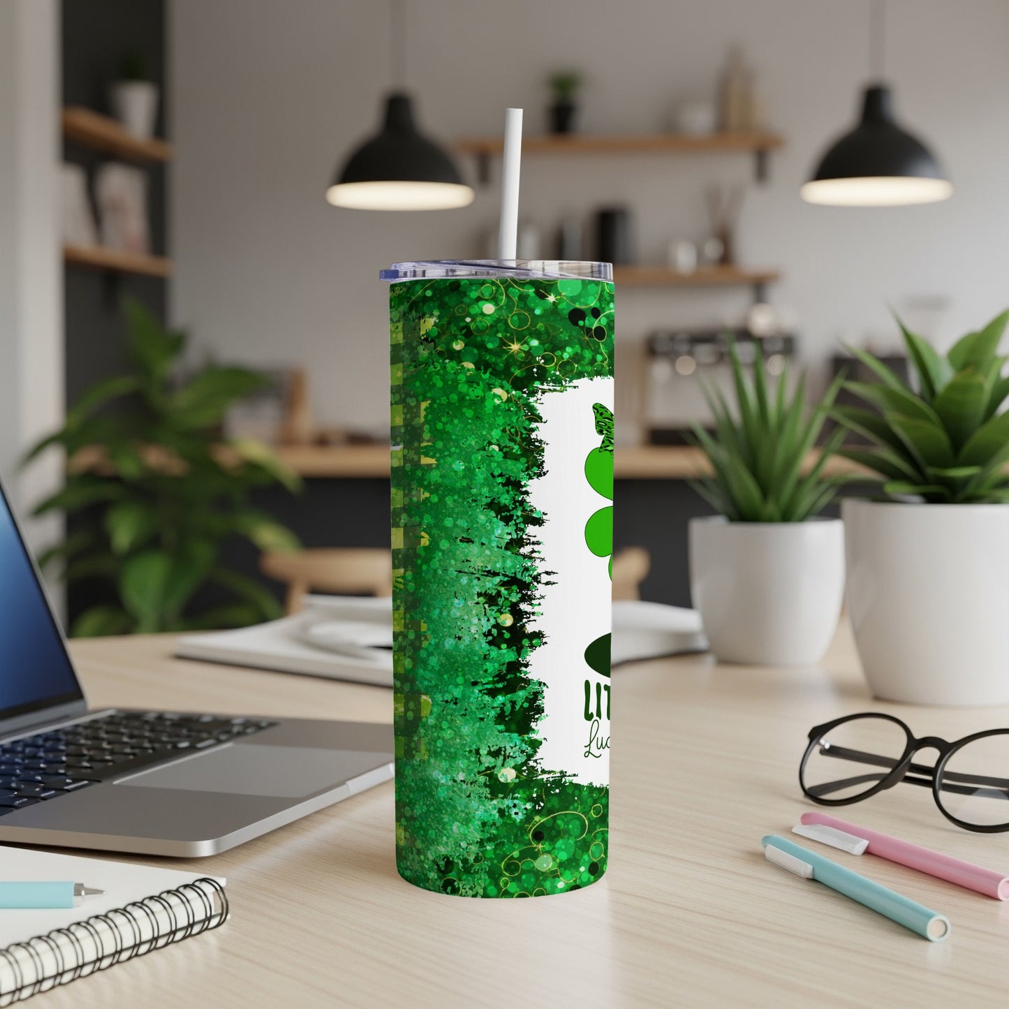 Green sparkly tumbler with "Little bit lucky" text and shamrocks.