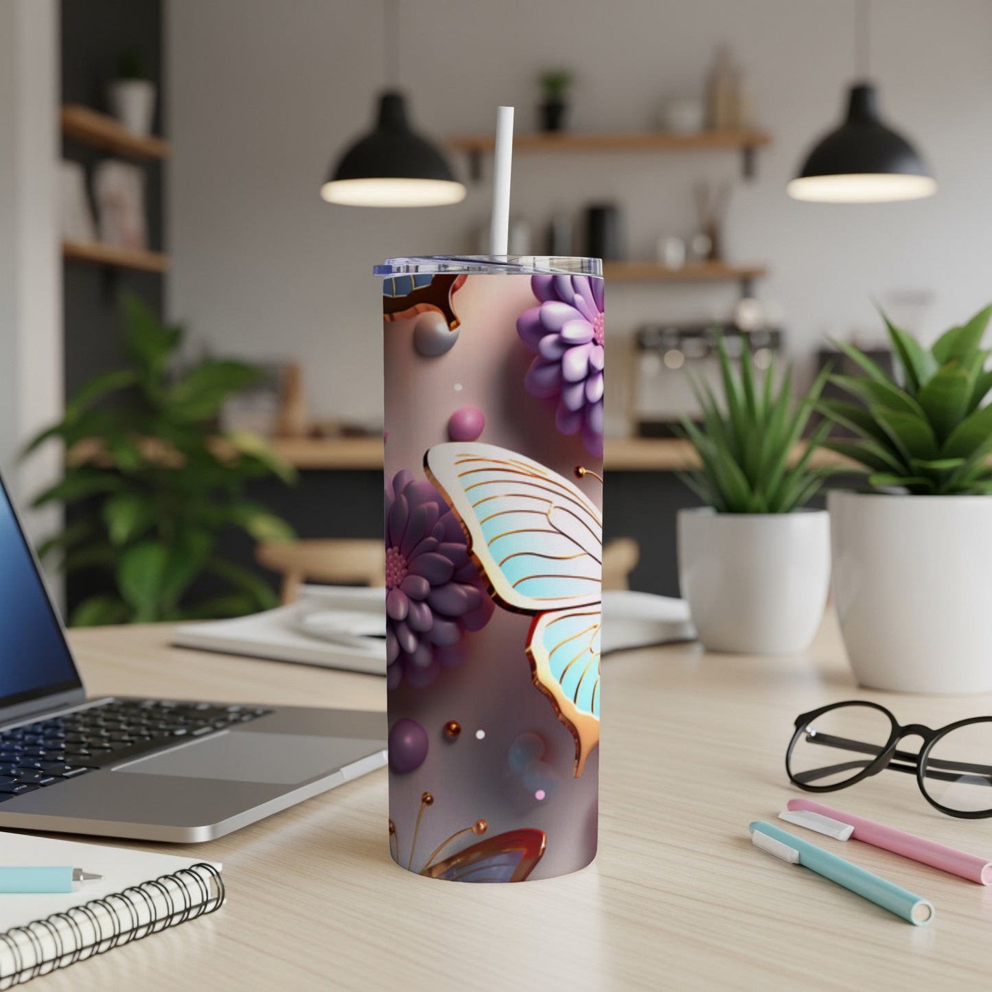 Butterfly and floral patterned tumbler with a straw.