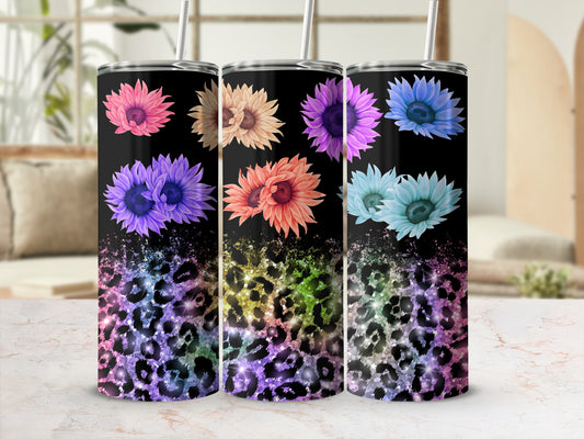 Three tumblers with colorful floral and leopard print designs.