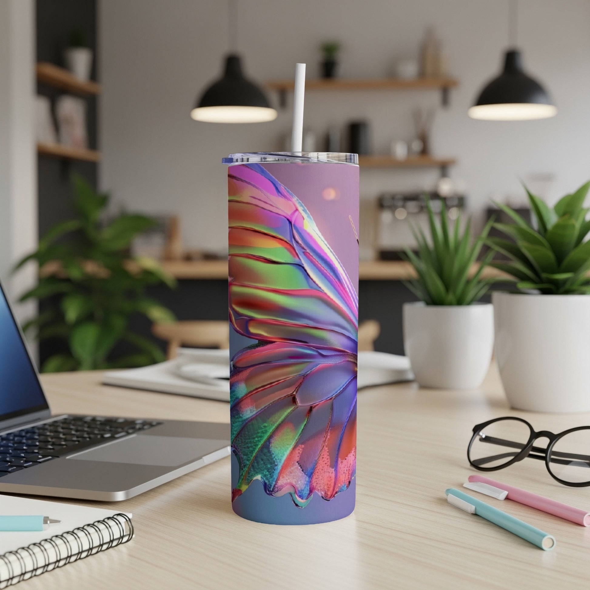 Iridescent butterfly wing design on a stainless steel tumbler with straw.