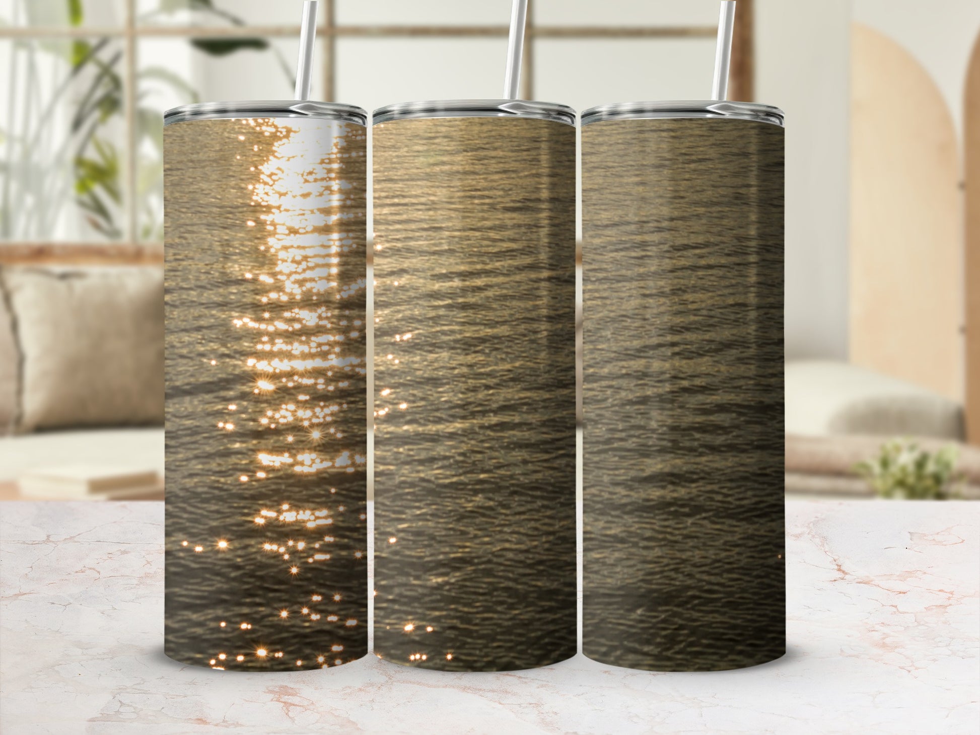 Three tumblers displaying a golden water reflection design.