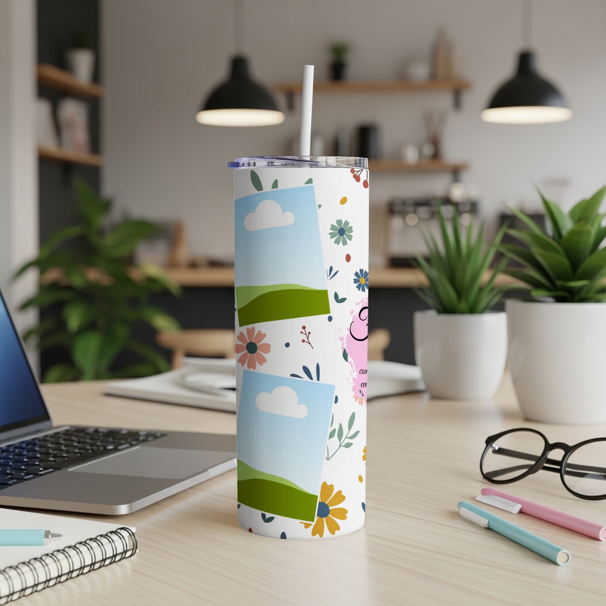 Tumbler with scattered flowers and photo frames, including a pink heart.