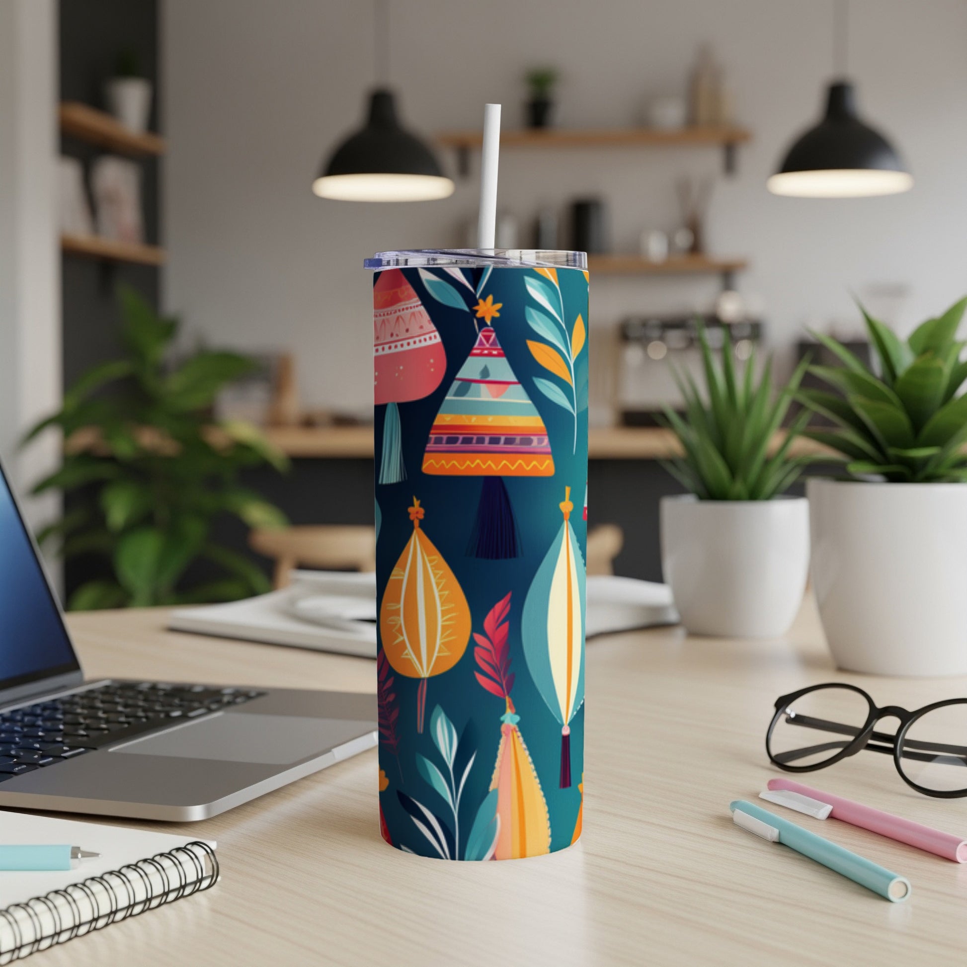 Tumbler with colorful abstract desert plant pattern and white straw.