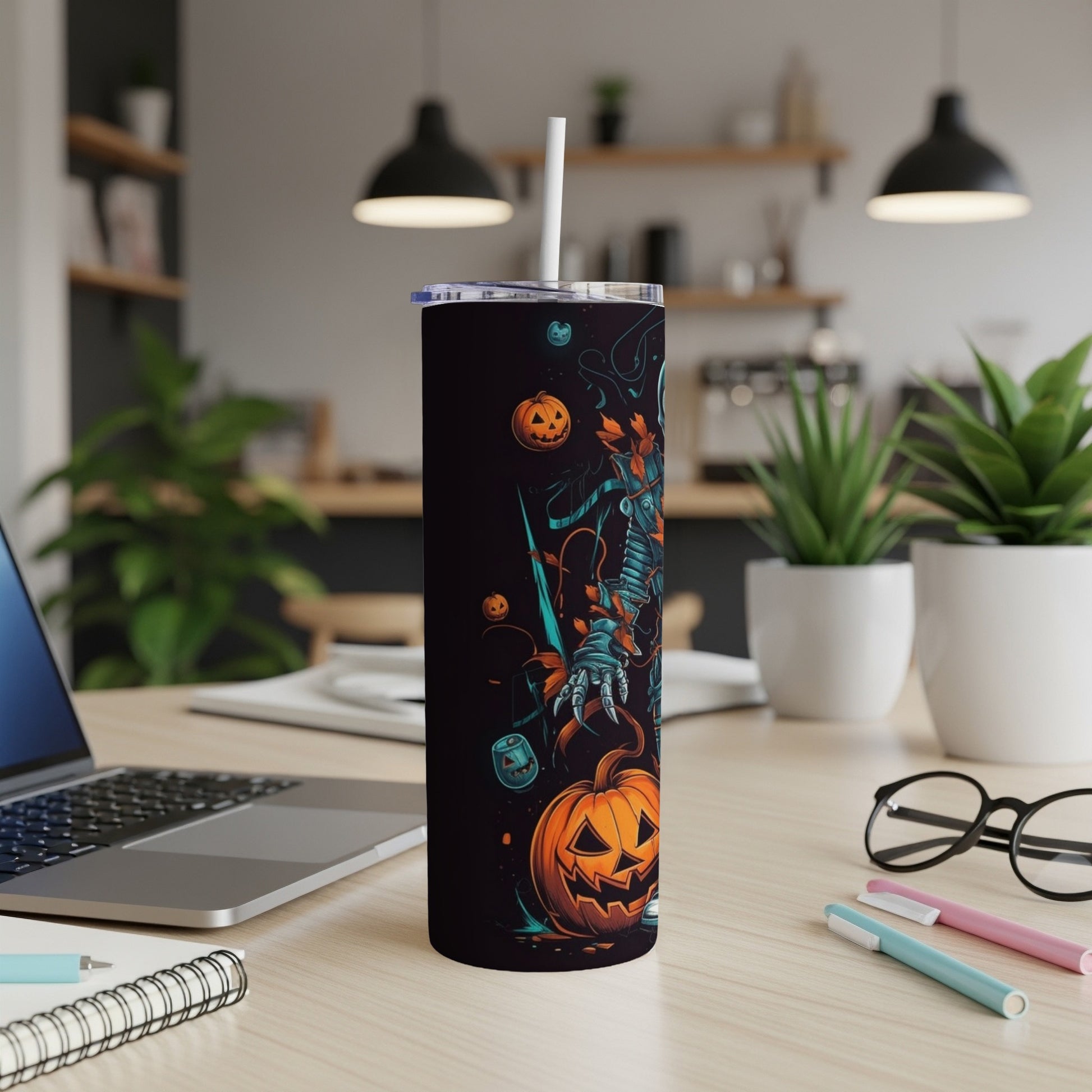 Black tumbler with Halloween skeleton and pumpkin graphic, featuring a straw.