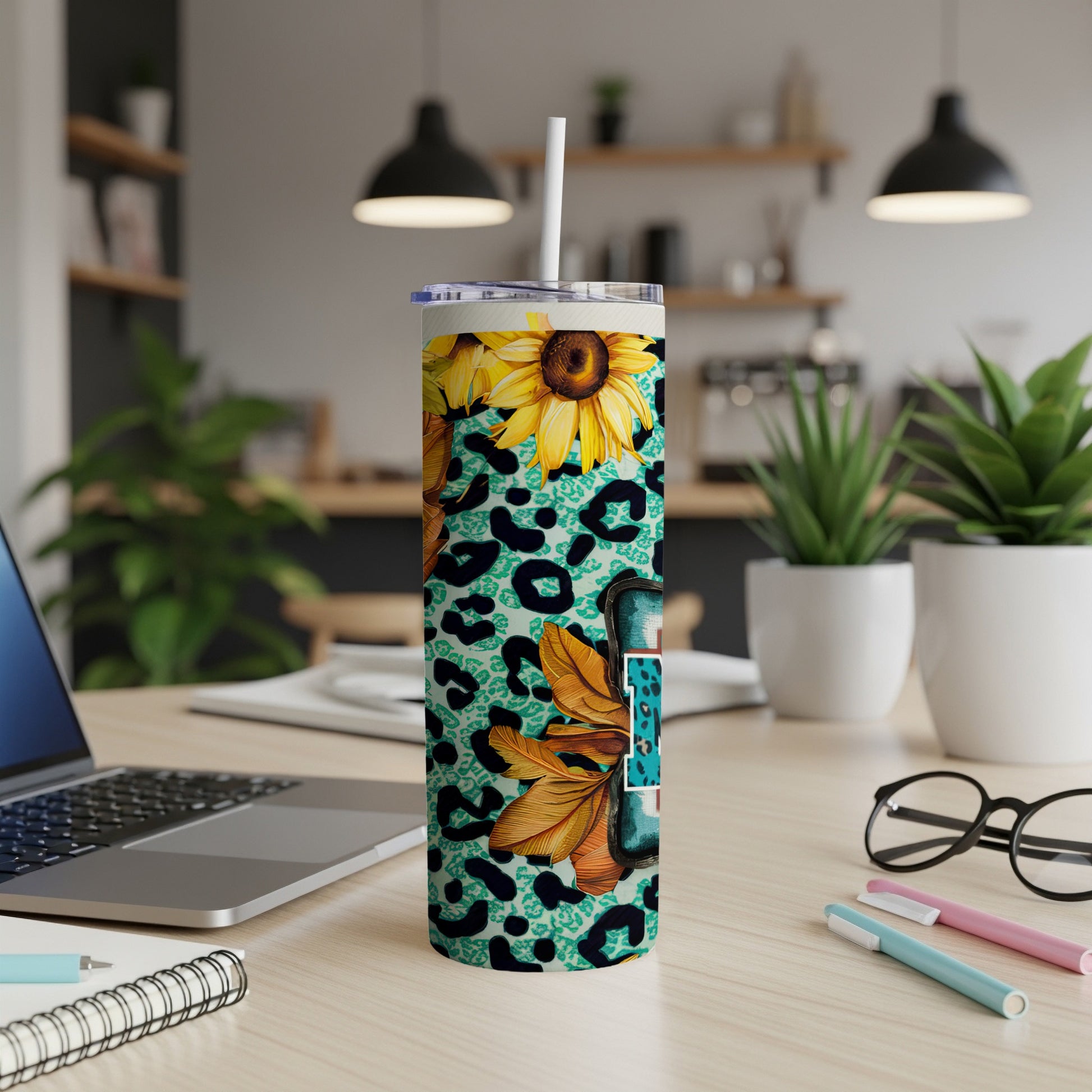 Tumbler with teal leopard print, sunflowers, and gold "Fall" text.