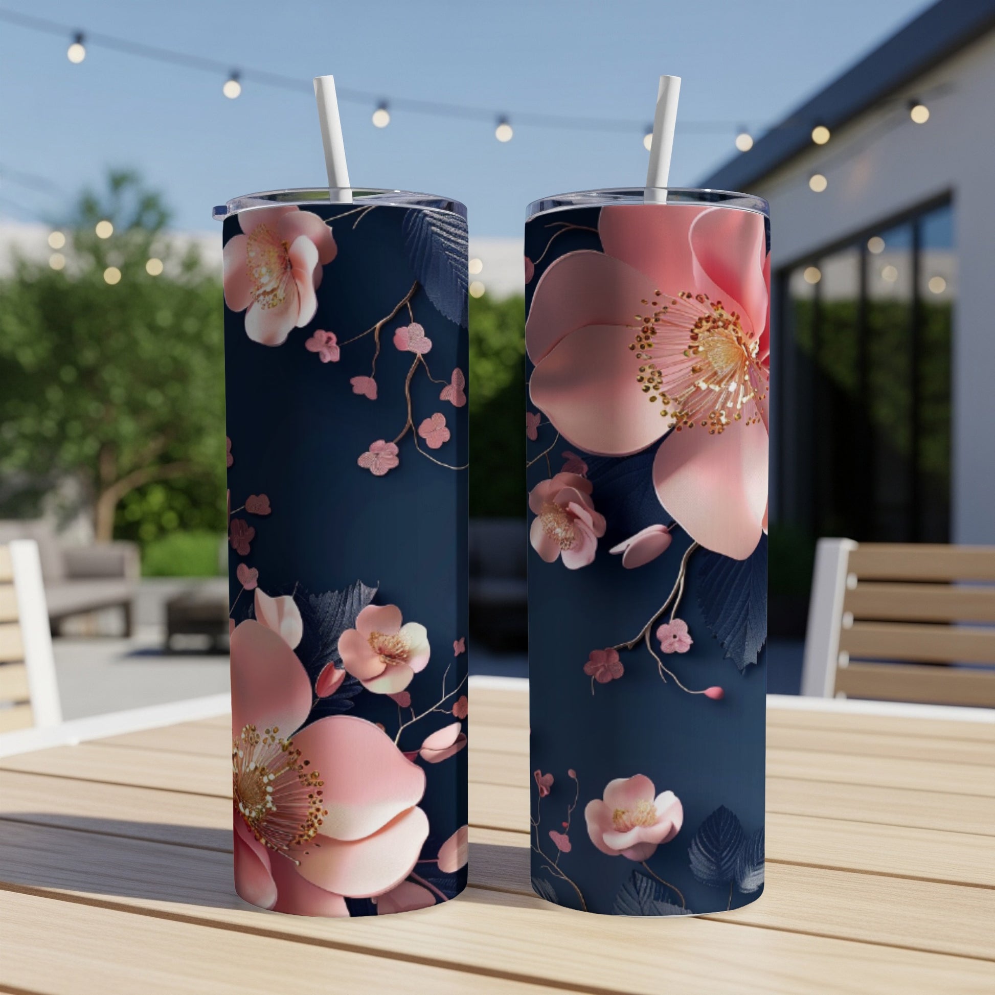 Two dark blue tumblers with pink floral and dark blue leaf pattern.