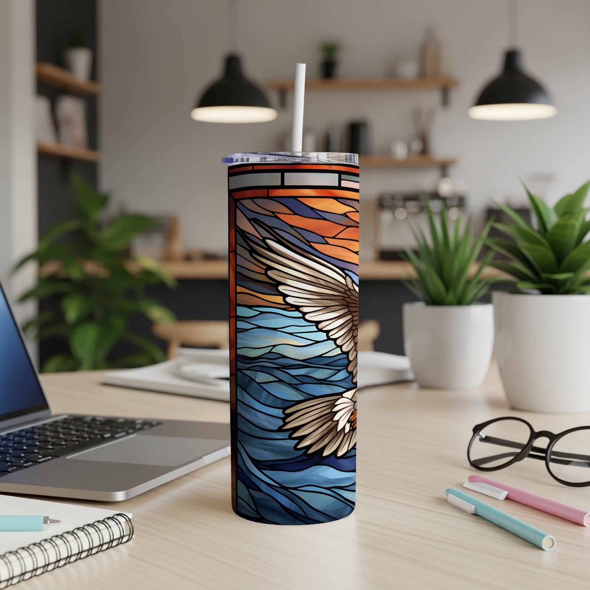 Stained glass tumbler with soaring eagle design on wavy water background.