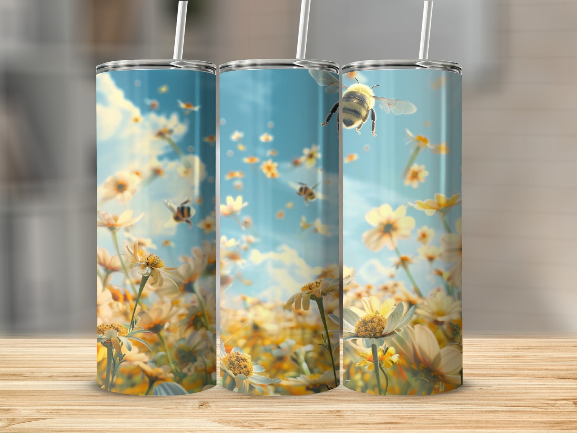 Three tumblers with bees and flowers, set on a wooden surface.
