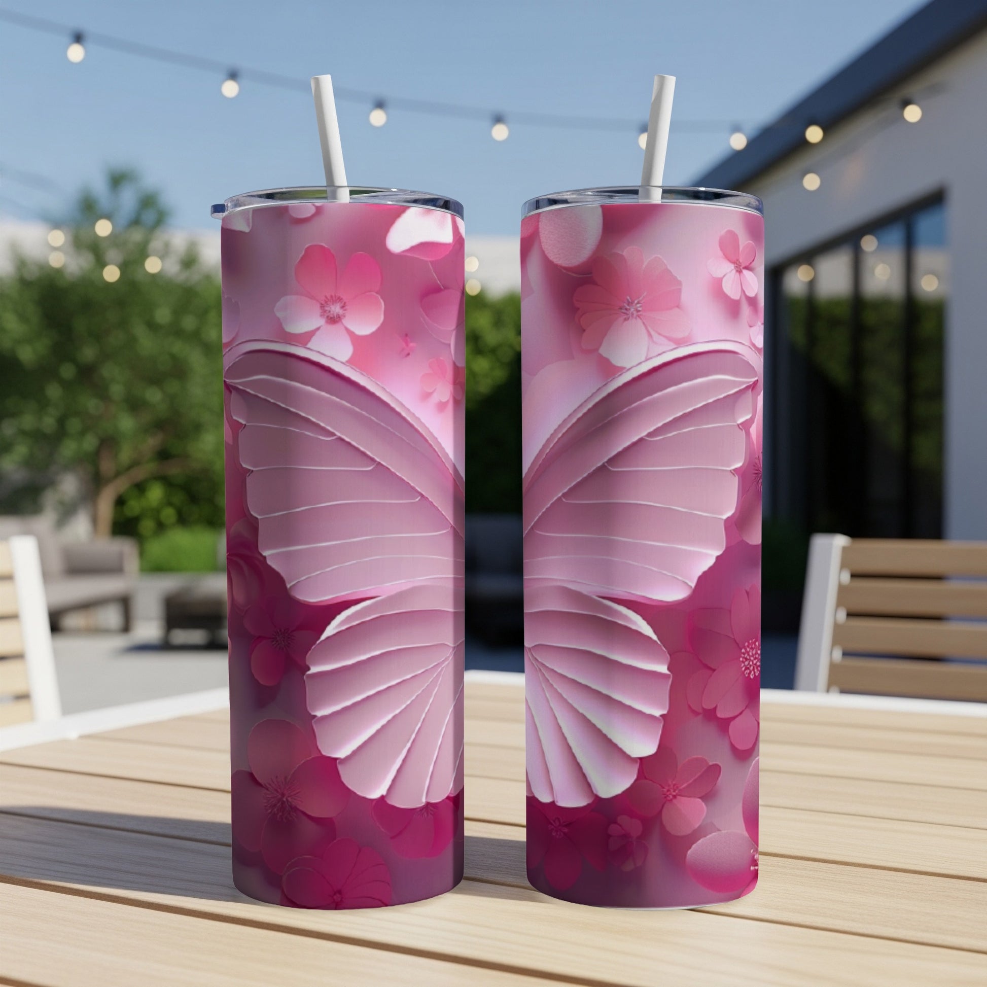 Two tall pink tumblers with butterfly wing and floral designs.