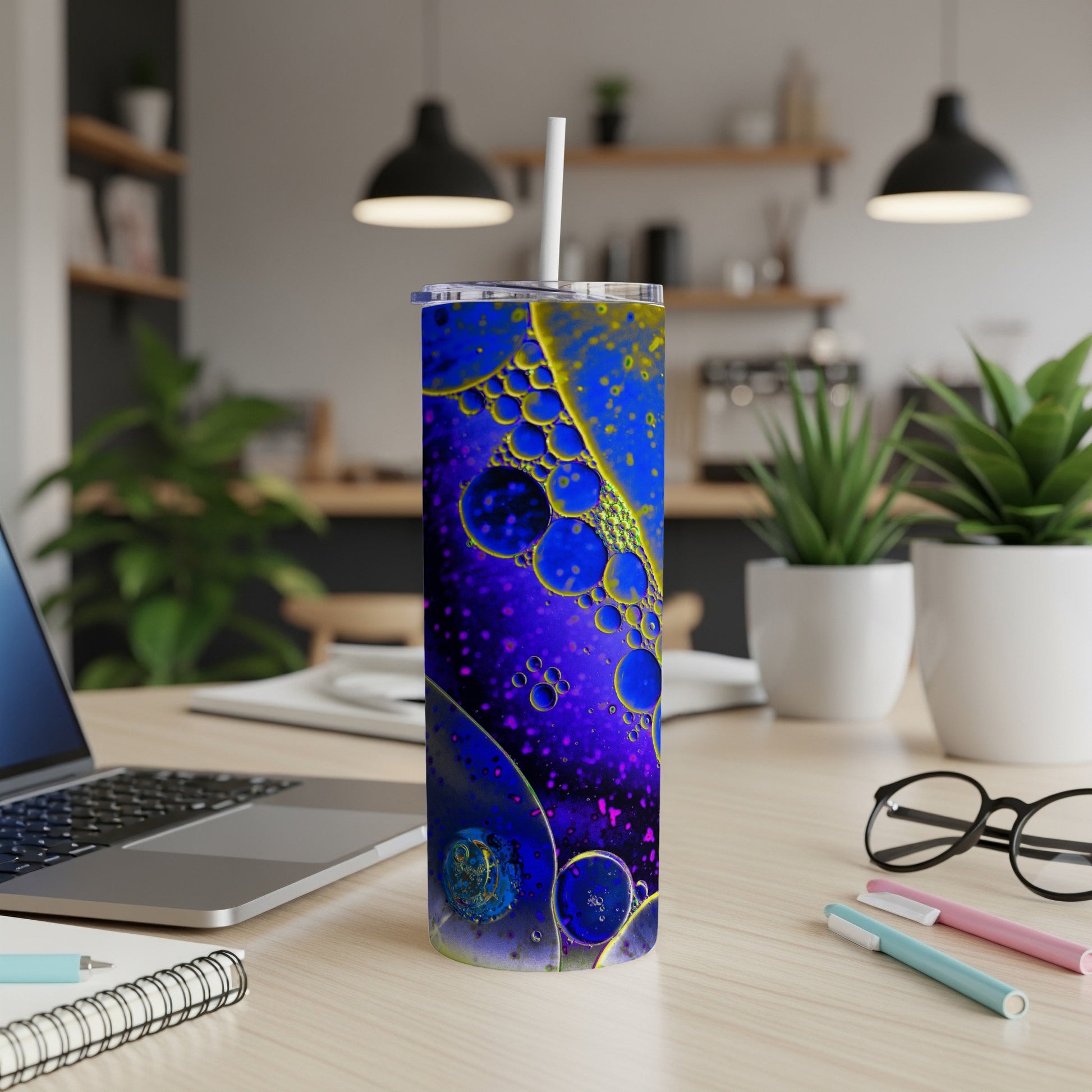 Purple tumbler with abstract oil and water pattern and a straw.