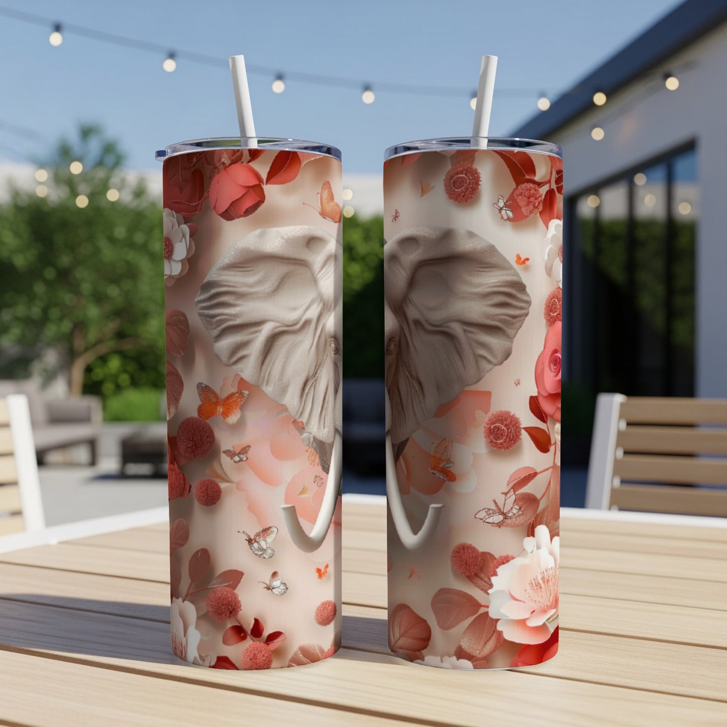 Two tumblers with an elephant and floral design on a table.