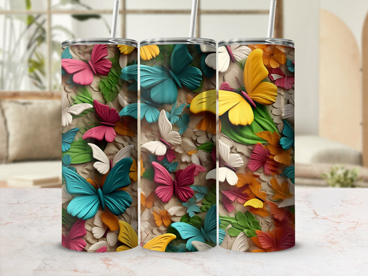 Three tumblers with colorful butterfly and floral designs.