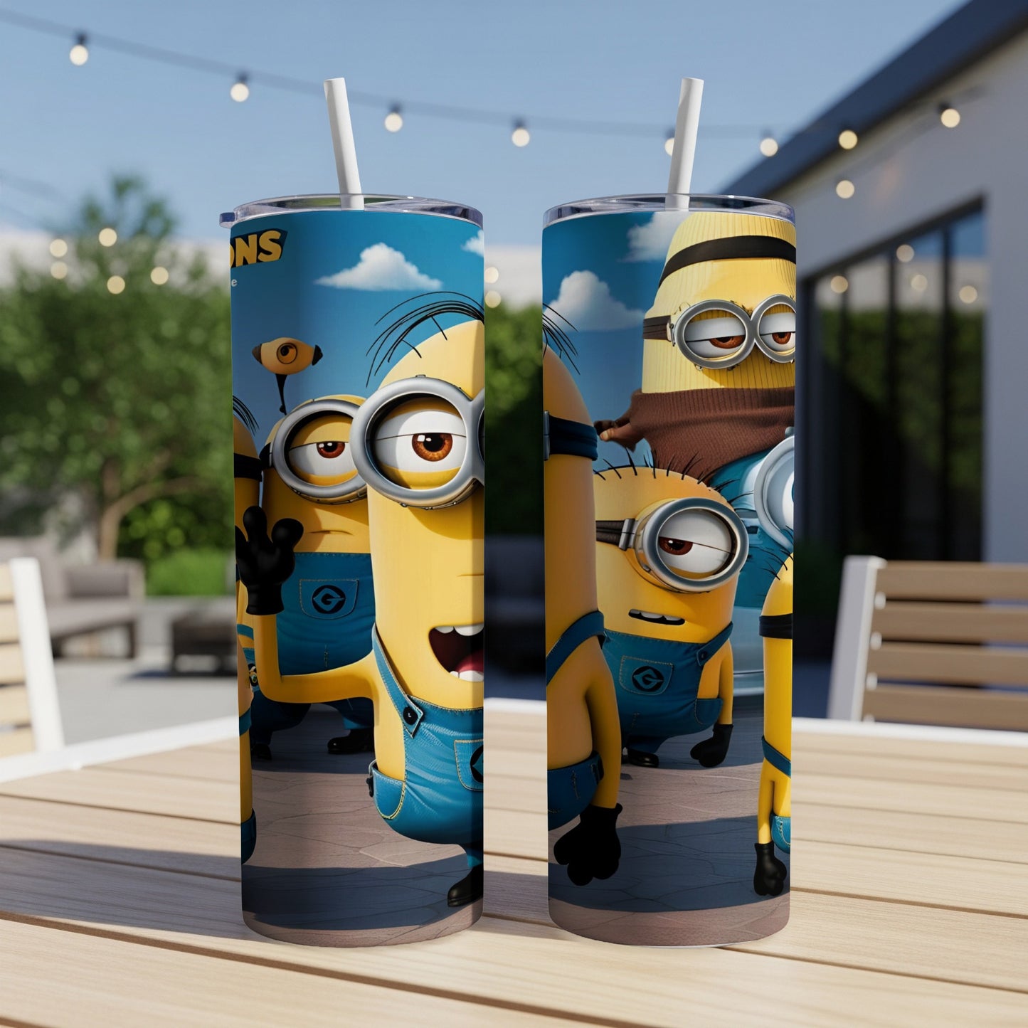 Two Minions tumblers with straws sit on a table.