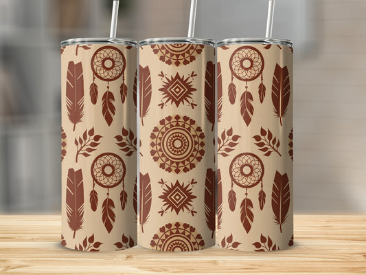 Three tan tumblers with feather and dreamcatcher patterns on a wooden surface.