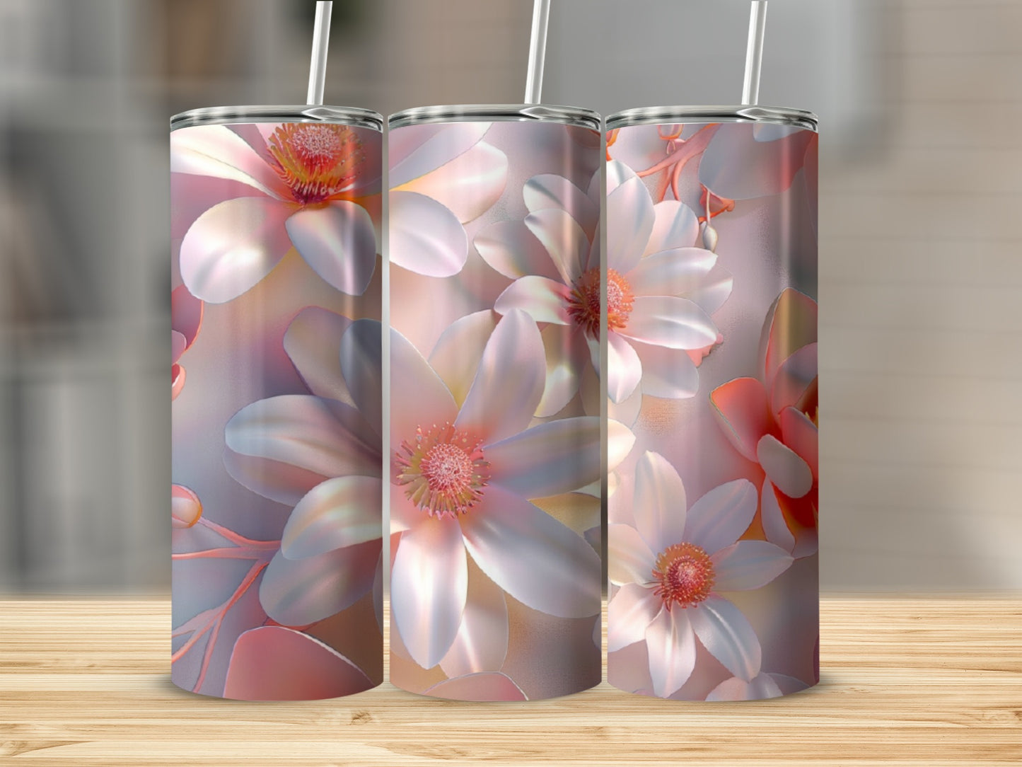Three tumblers with a pink and white floral design on a wooden surface.