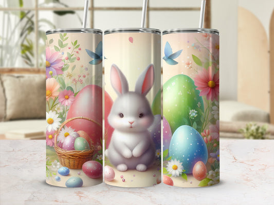 Easter bunny surrounded by colorful eggs, flowers, and birds on a patterned tumbler.