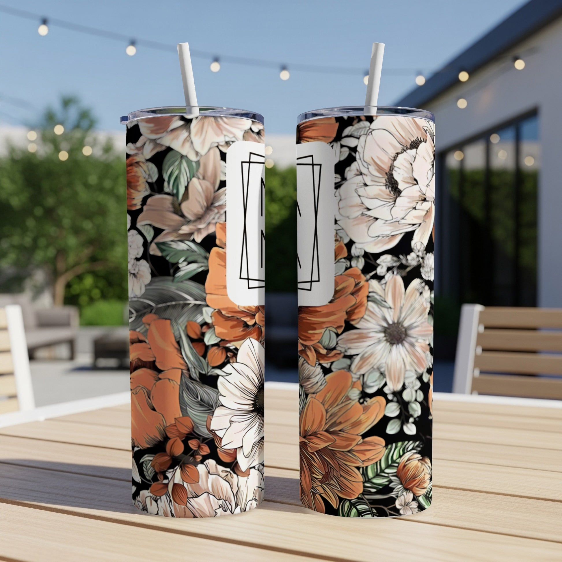 Two tumblers featuring a floral pattern with white and orange flowers.