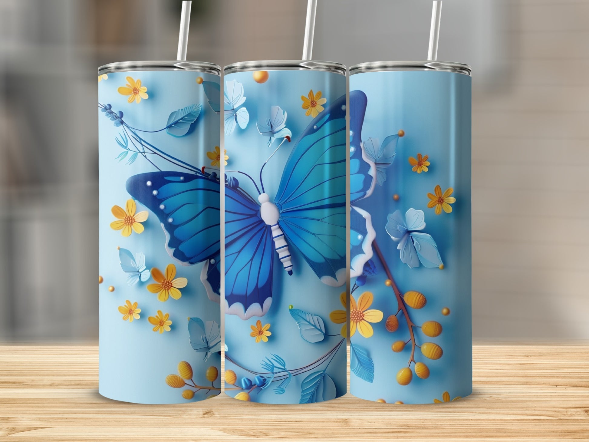 Three light blue tumblers with a large blue butterfly and yellow flowers design.