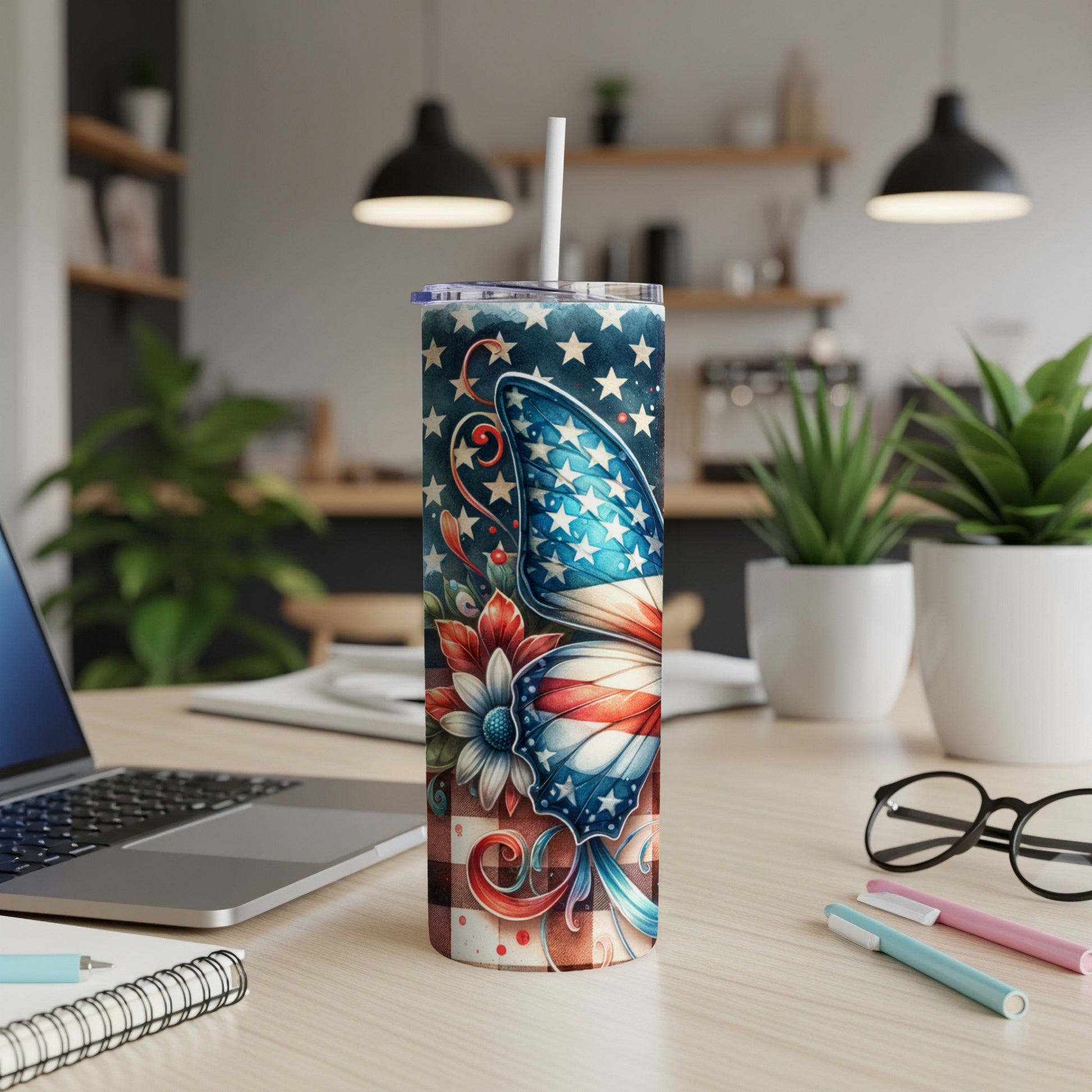 Tall tumbler with American flag butterfly design and straw.