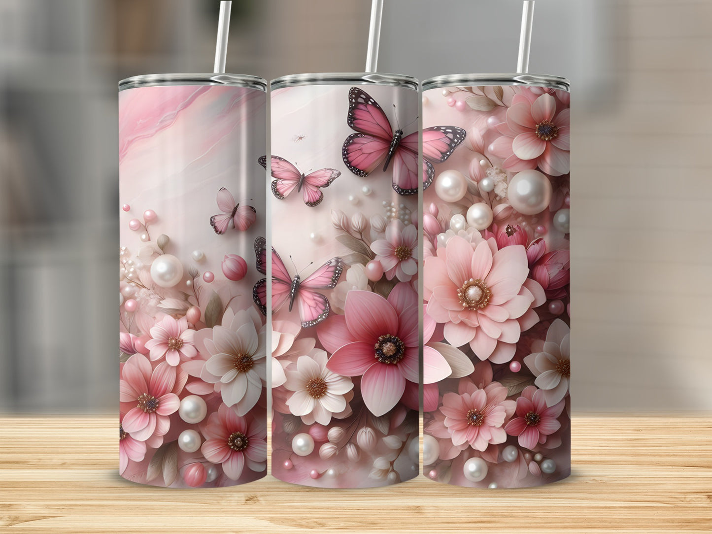 Three tumblers with pink floral and butterfly designs.