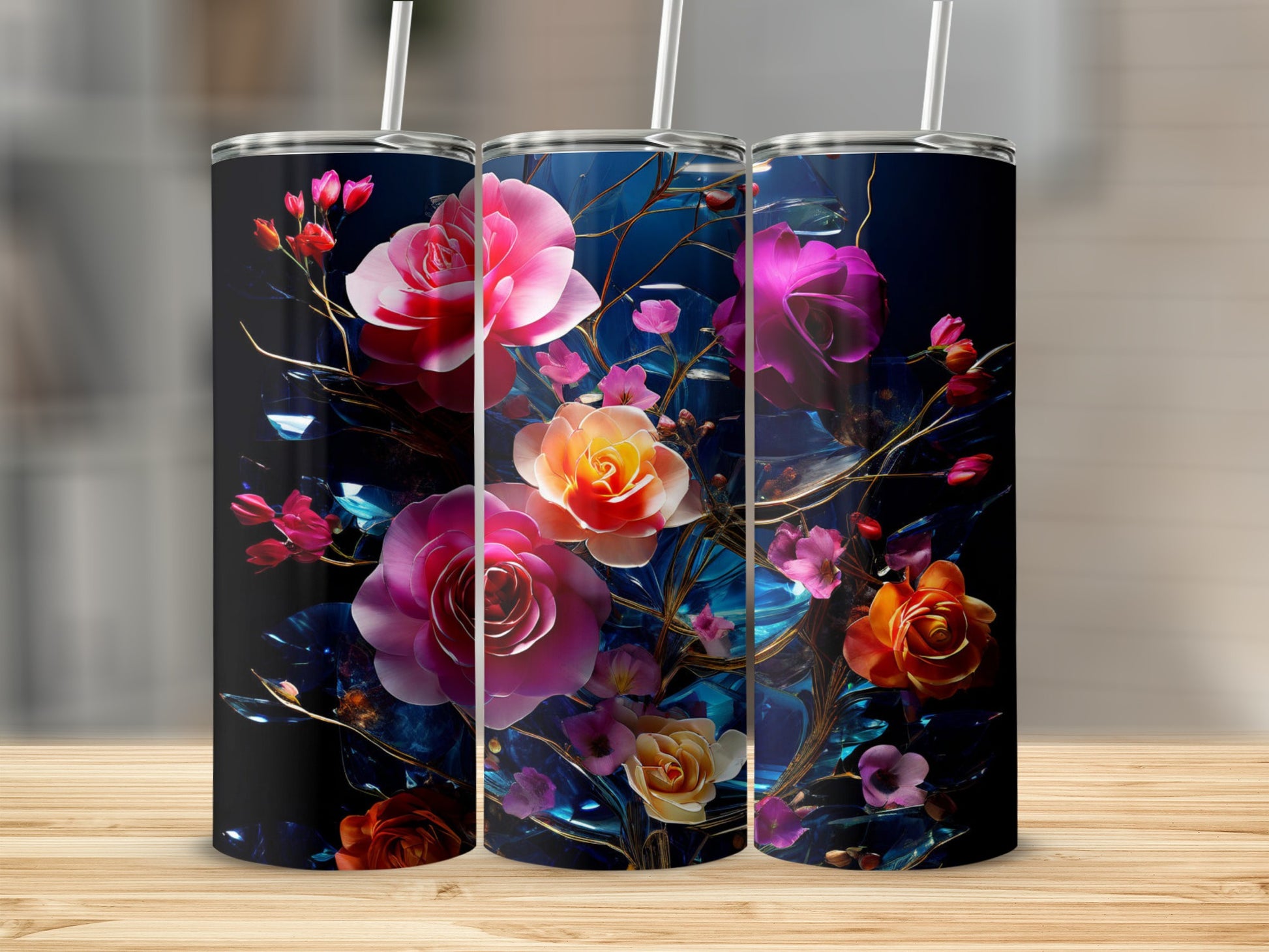 Three tumblers featuring vibrant pink, orange, and yellow floral designs on a dark background.