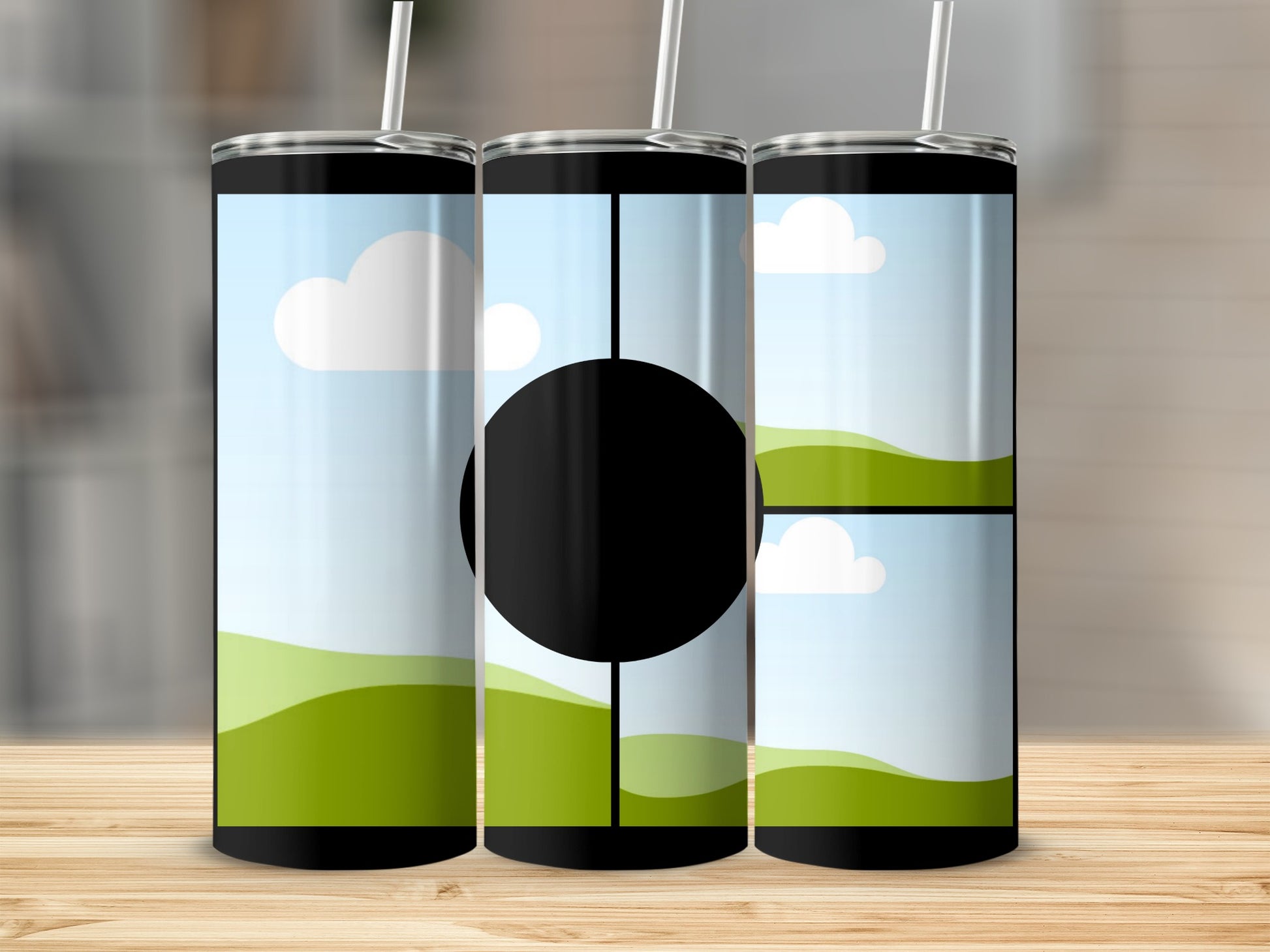 Three tumblers with a landscape design and a black circle on the middle tumbler.