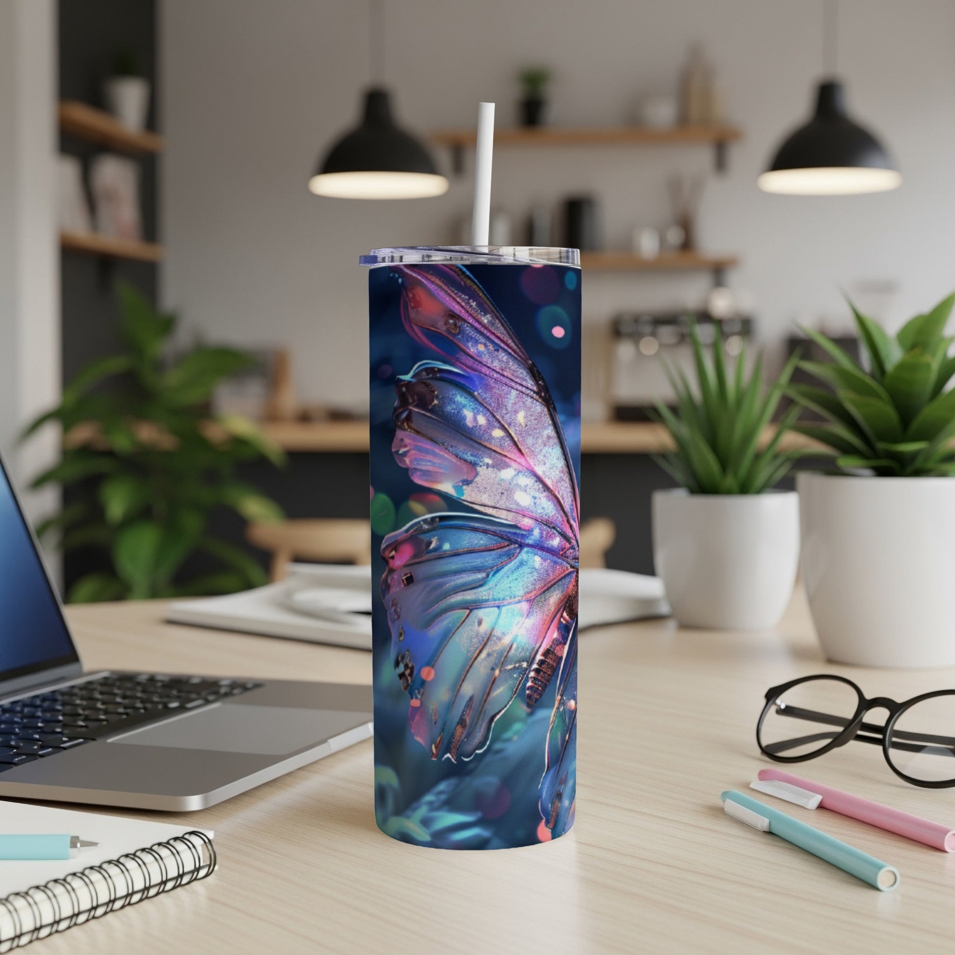 Tumbler with colorful, glowing butterfly wing design.