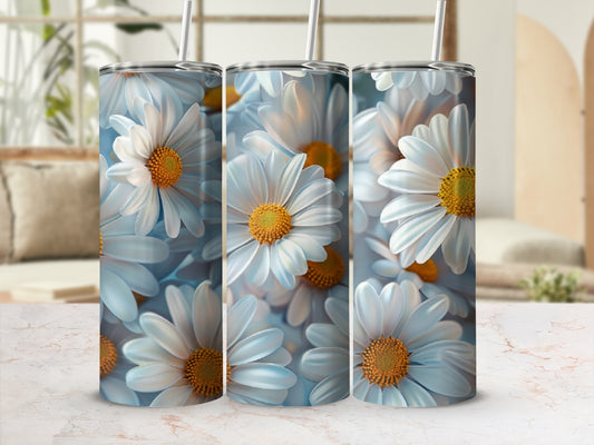 Three white daisies with yellow centers on a tumbler.