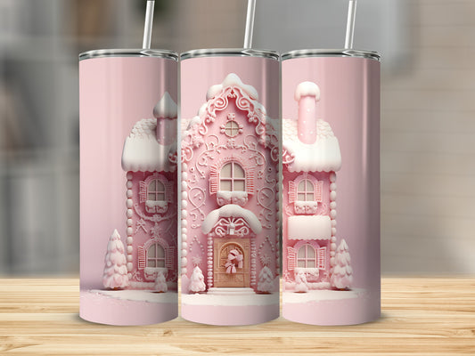 Three pink gingerbread houses with snow on a wood surface.