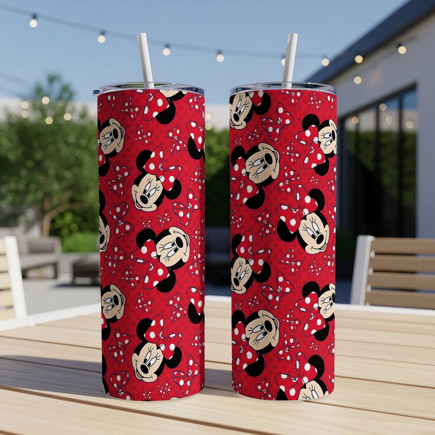 Two Minnie Mouse patterned tumblers with red bows and polka dots on a table.