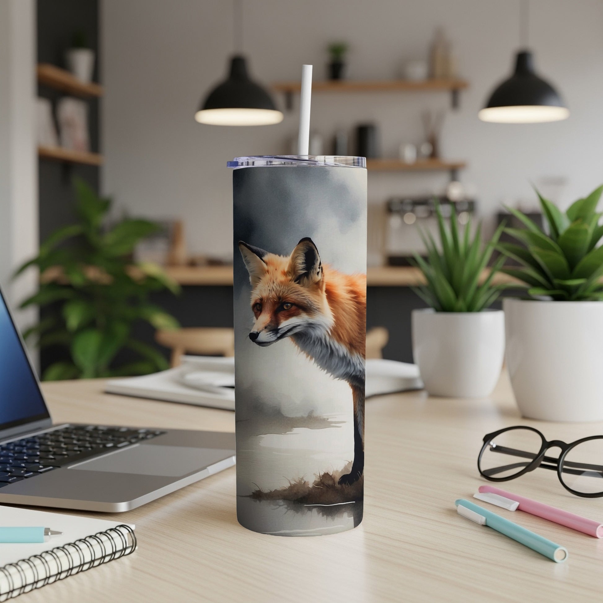 Realistic fox illustration on a white tumbler with a straw, on a desk.