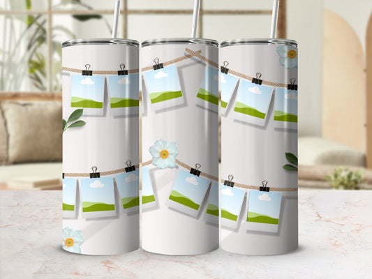 White tumblers with photos clipped to a twine line and floral accents.