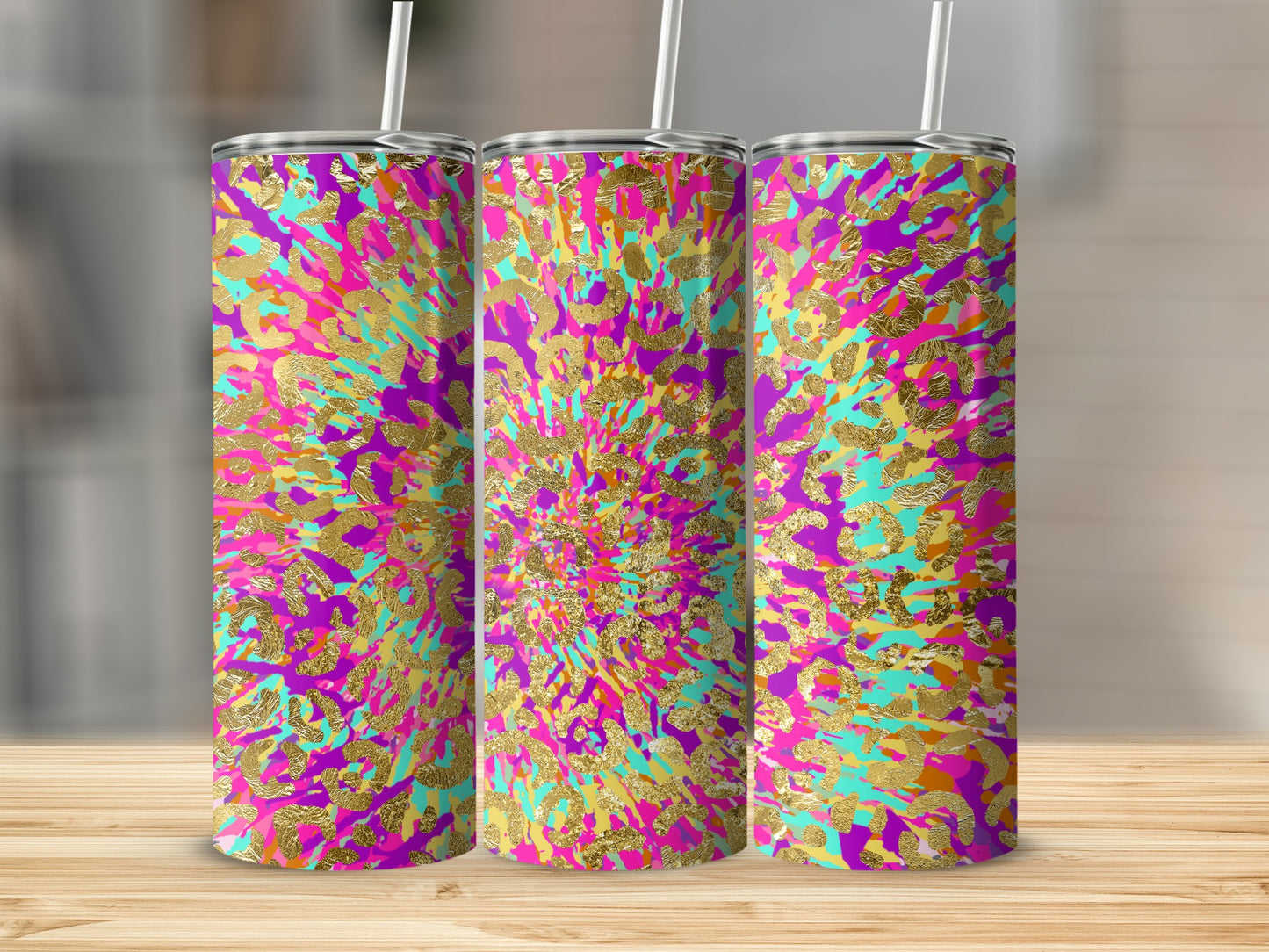 Three skinny tumblers with vibrant tie-dye and gold leopard print pattern.