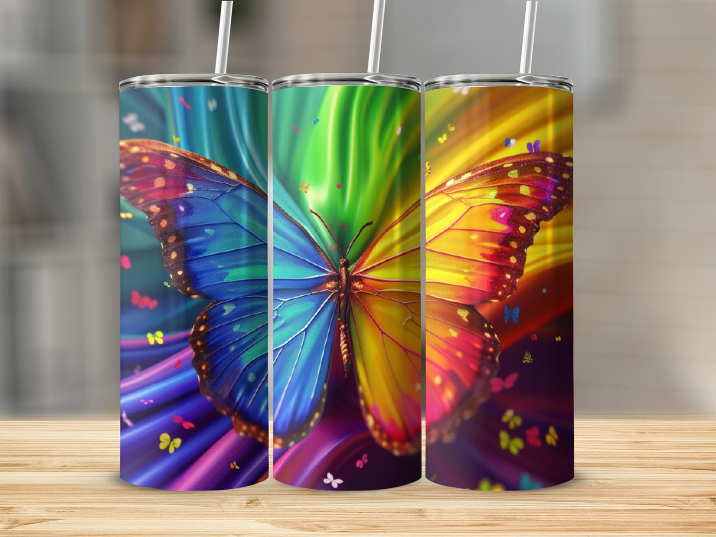 Three colorful tumblers with butterfly and rainbow designs.