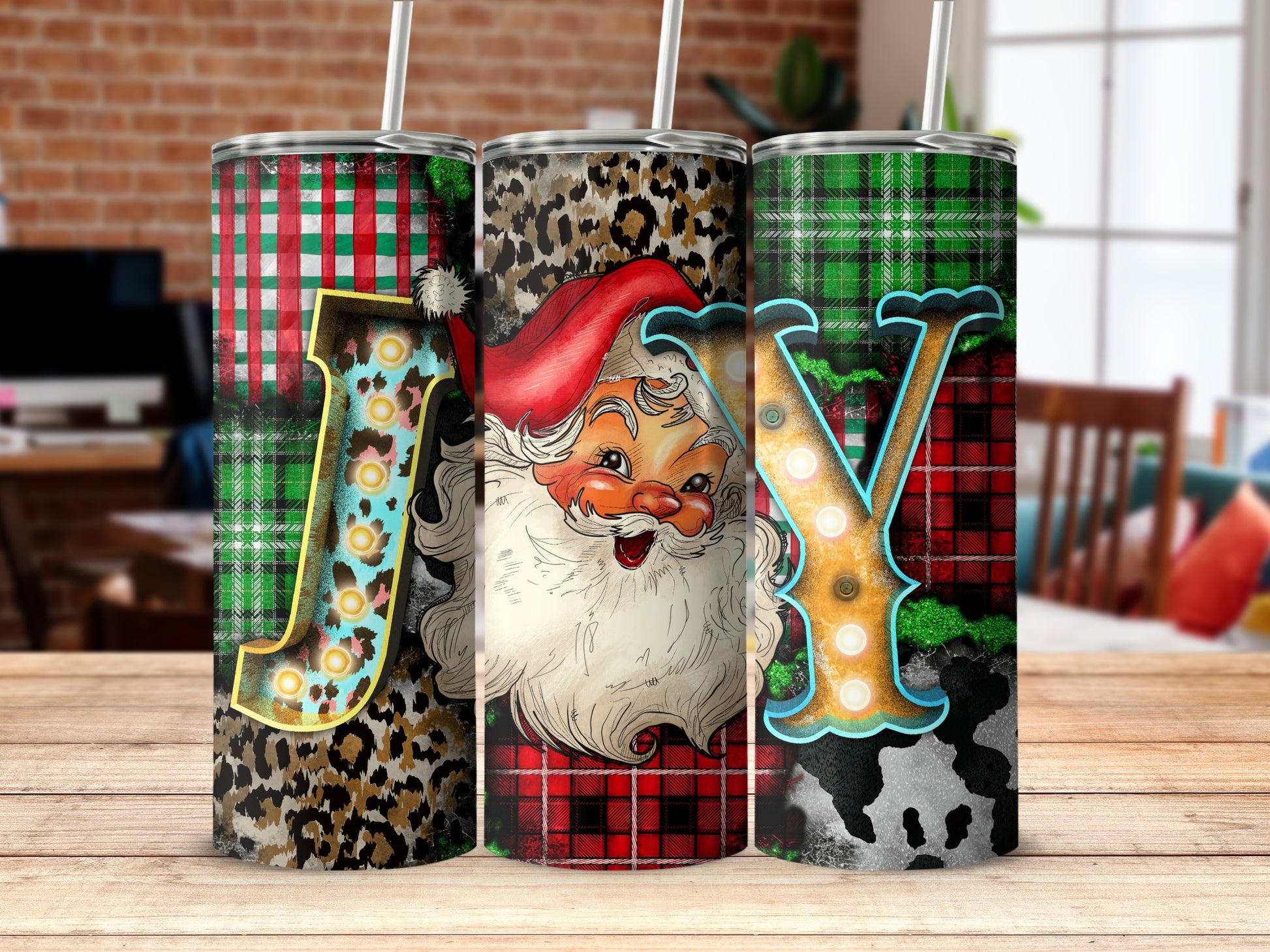 Three festive tumblers with Santa, leopard print, and plaid patterns.
