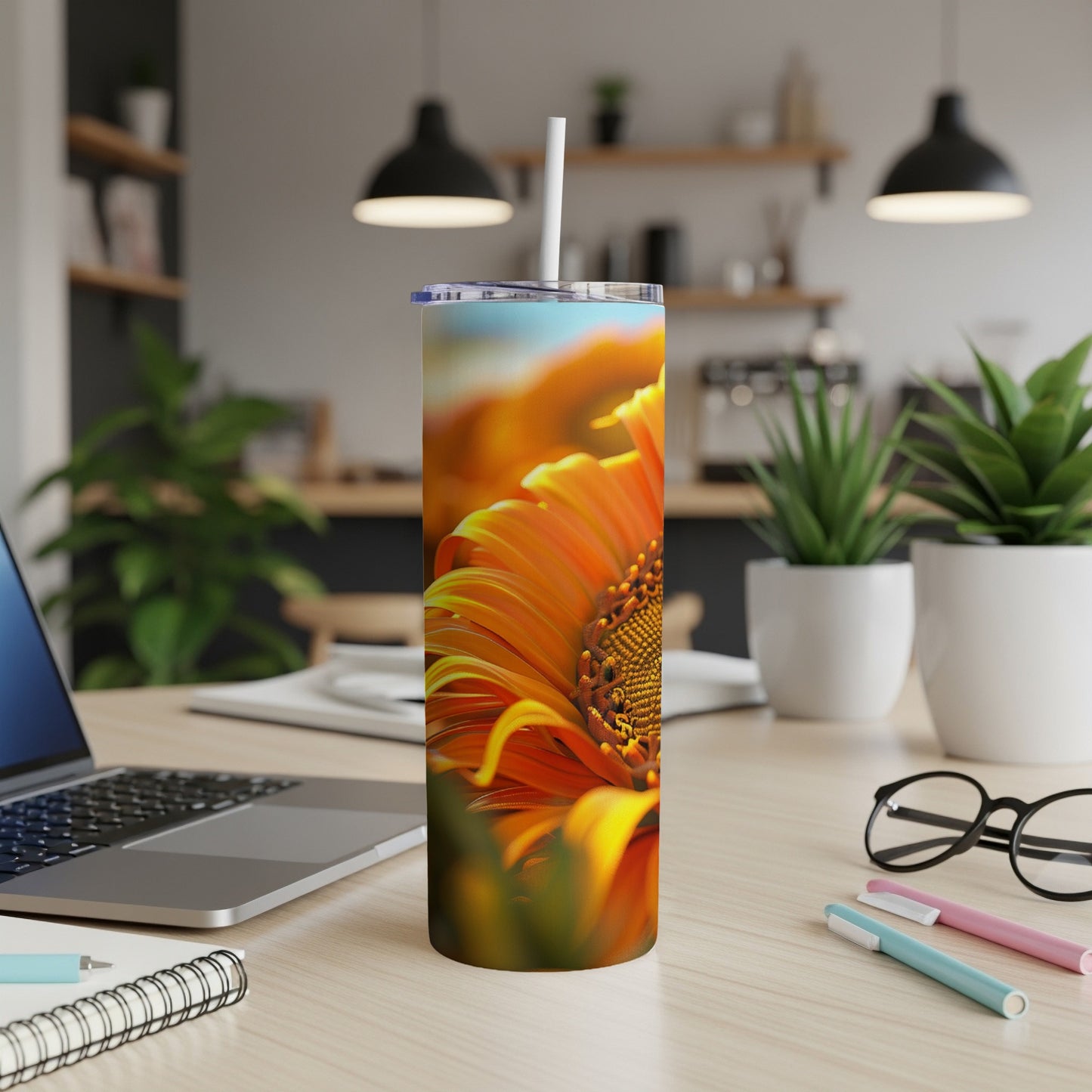 Close-up of a vibrant orange sunflower on a white tumbler with a straw.